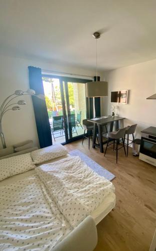 a bedroom with a bed and a dining room at LittleBalaton- Pool, sauna in Alsóörs