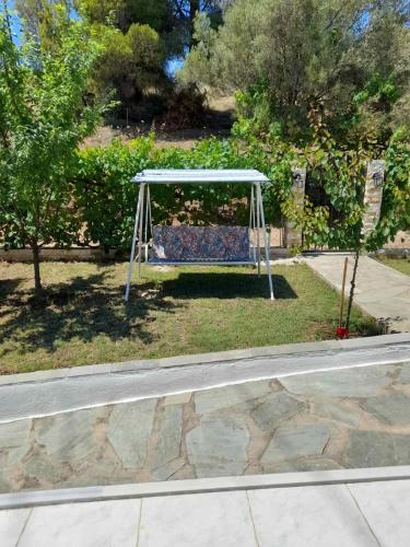 a swing set on the side of a road at Dimitra House in Metamorfosi