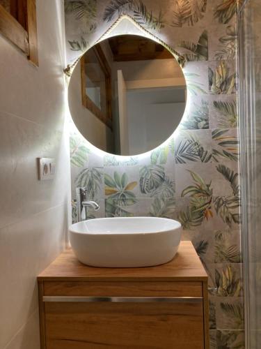 a bathroom with a sink and a mirror at Apartamentos Rio Loba Ruiloba costa Cantabria in Ruiloba