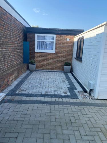 a driveway in front of a house with a garage at Casa do Pedro in Portslade