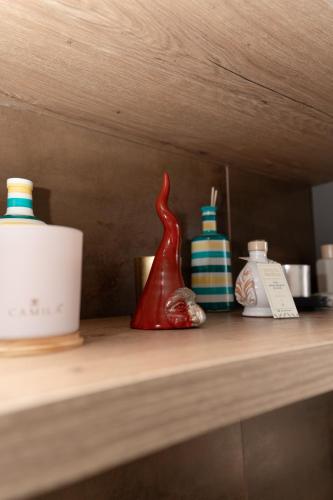 a shelf with three bottles on top of it at Kira suite and rooms in Pozzuoli