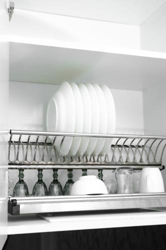 a shelf with plates and vases in a refrigerator at Guesthouse - 3 room in Sumqayyt