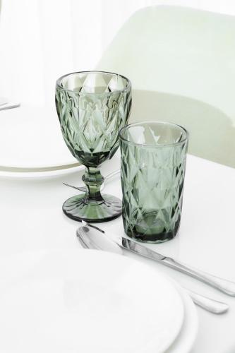 a pair of green glass glasses sitting on a table at Guesthouse - 3 room in Sumqayyt