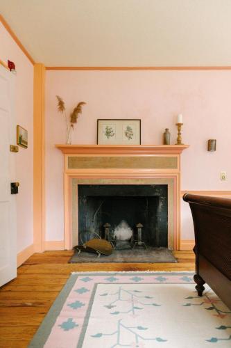 a living room with a fireplace and a rug at Eileen of Mystic in Mystic