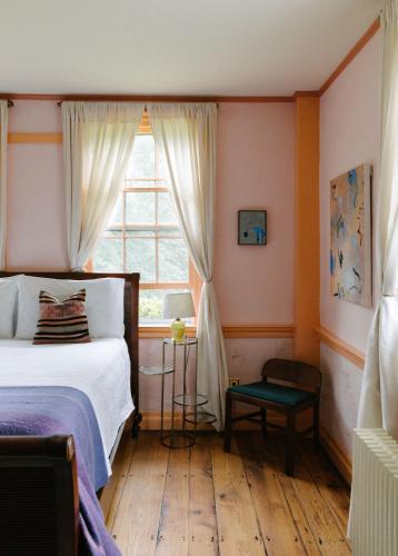 a bedroom with a bed and a window at Eileen of Mystic in Mystic