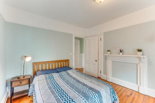 a bedroom with a bed and a fireplace at Charming Victorian Retreat with Hudson River Views in Newburgh