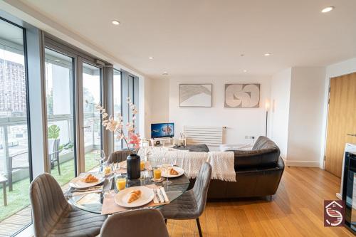 a living room with a table and a couch at The Canning Comfort in London