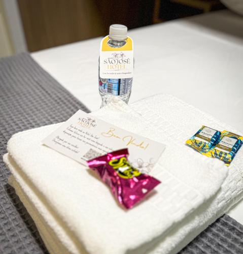 a bottle of water sitting on top of a towel at Hotel São José in São José