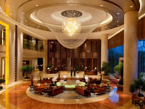 a lobby with a large chandelier in a building at HJ International Hotel in Dongguan