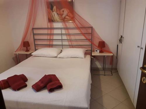 a bedroom with a bed with two pillows on it at Any Summer garden house in Skála Nikíta