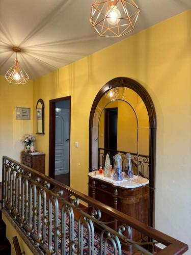 a room with a staircase with a mirror on the wall at Casa das Oliveiras in Celorico de Basto