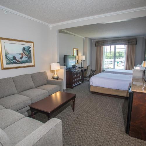 a hotel room with a bed and a couch at Fort William Henry Hotel in Lake George