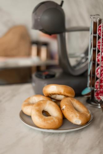 four donuts sitting on a plate on a counter at LakEscape - Waterfront Self- Catering Cabins in Enniskillen