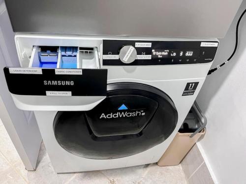 a washing machine with a box on top of it at 1BR By The Airport at Amani Grand Residences in Lapu Lapu City
