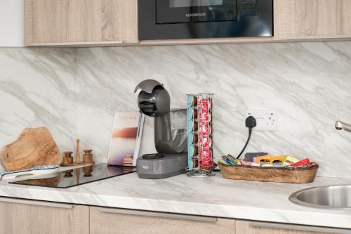 a kitchen counter with a mixer and a sink at LakEscape - Waterfront Self- Catering Cabins in Enniskillen