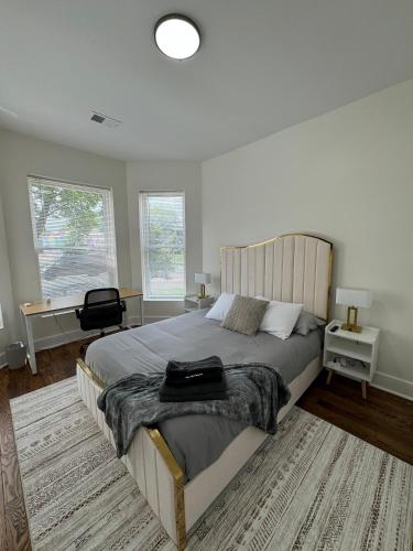 a bedroom with a large bed and two windows at Chic Euro City Getaway- Close to Downtown in Chicago