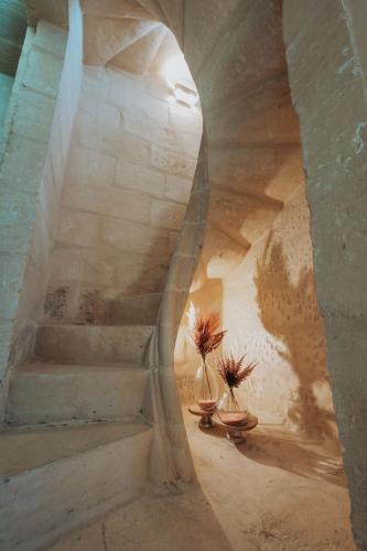 a stairway with two plants in vases in a building at Casa Rosanna Malta B&B Adults only 16 plus in Marsaskala