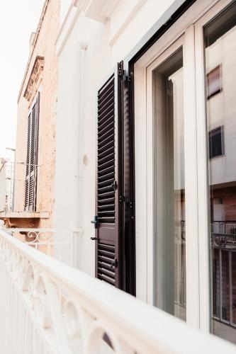 a balcony with a black door on a building at Aparthotel Camere del Capitolo in Bisceglie