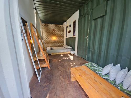 a living room with a couch in a room at Zero Meia Um Pousada in São Miguel do Gostoso