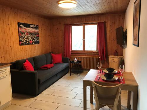 a living room with a couch and a table at Bergesrueh in Malix