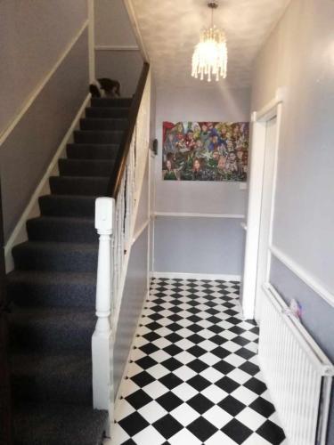 a hallway with a black and white checkered floor at North Edinburgh - Shared house bwith own room and bathroom in Edinburgh