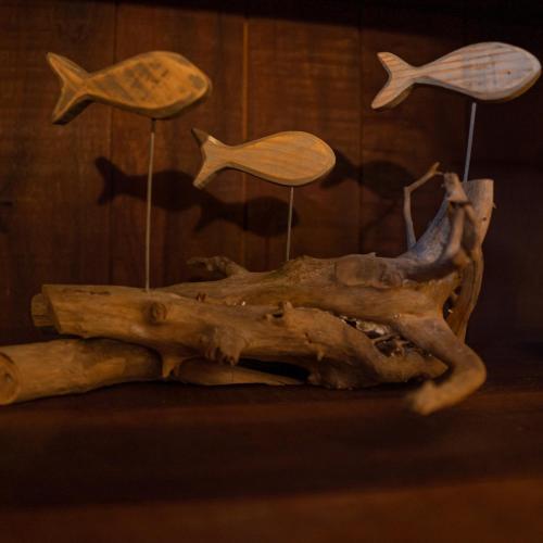 a piece of wood with different types of fish on it at Vila Guará in Atins
