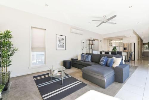 a living room with a couch and a table at TWELVE at 12 Private Central Maroochydore in Maroochydore