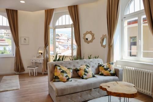 a living room with a couch and a table at Biosphere Lux Apartments in Sarajevo