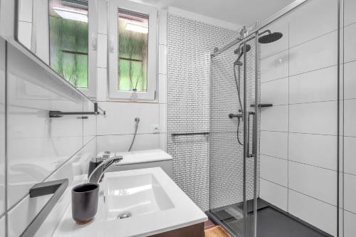 a white bathroom with a sink and a shower at Apartment Villa Hřensko 132 in Hřensko