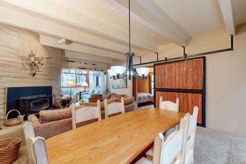 a dining room and living room with a wooden table at Predock 1A in Taos Ski Valley