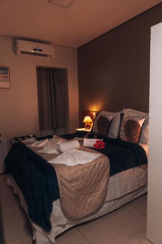 a bedroom with a large bed in a room at Pousada Aconchego Noronha in Fernando de Noronha