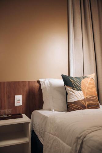 a hotel room with a bed and a window at Pousada Aconchego Noronha in Fernando de Noronha