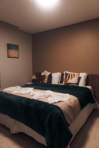 a bedroom with two beds with towels on them at Pousada Aconchego Noronha in Fernando de Noronha