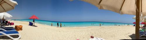 a beach with a lot of people in the water at Porto Matrouh unique Chalet in Marsa Matruh