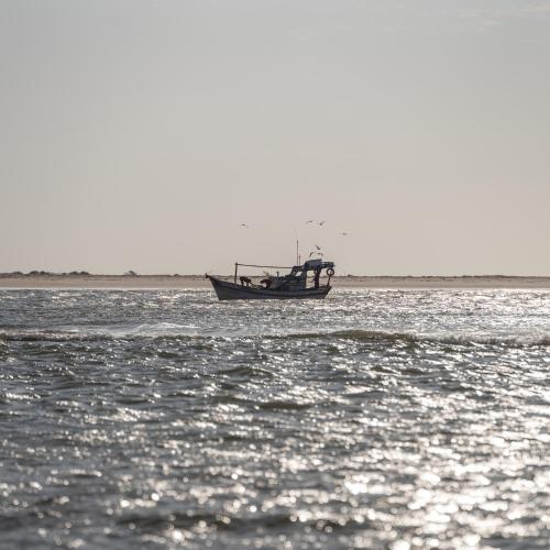 a boat sitting in the middle of the water at Vila Guará in Atins