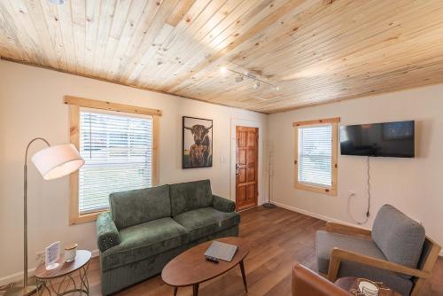 a living room with a couch and a tv at #StayinMyDistrict Brussels Bungalow in North Bend
