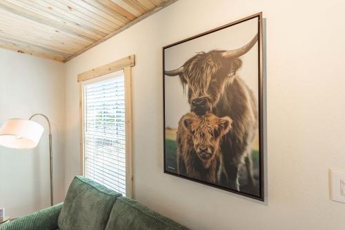 a picture of two cows hanging on a wall at #StayinMyDistrict Brussels Bungalow in North Bend