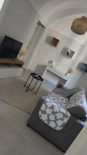 a bedroom with a bed and a desk and a television at Appartamento Bella Vista in Adrano