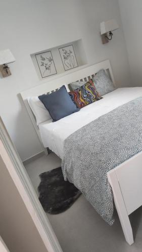 a bedroom with a bed and a table with pillows at Appartamento Bella Vista in Adrano