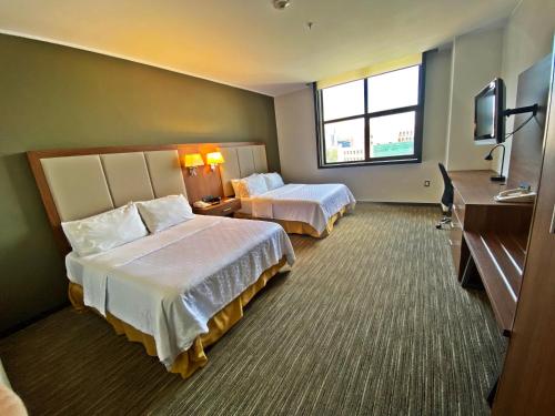 a hotel room with two beds and a television at Holiday Inn Express Mexico Santa Fe, an IHG Hotel in Mexico City