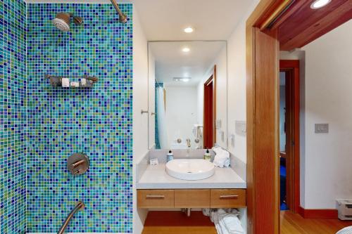 a bathroom with a sink and a blue tiled wall at Predock 2A in Taos Ski Valley