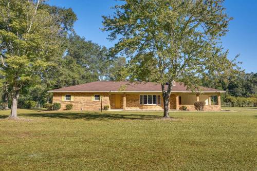 a house with a tree in front of it at Vintage Chipley Getaway on Large Private Property in Chipley
