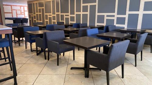 a dining room with tables and blue chairs at Holiday Inn Express Mexico Santa Fe, an IHG Hotel in Mexico City