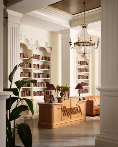 a living room with a large book shelf at Memoir Warehouse District in New Orleans