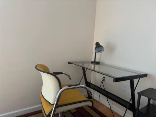 a desk with a chair and a table with a lamp at Lovely 2 Bedrooms Apartment in Scotch Plains