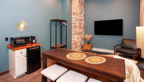 a living room with a table and a tv at The Intrepid Rentals in Duluth