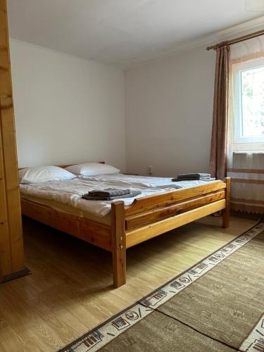 a bedroom with a wooden bed in a room at Plai in Dragobrat