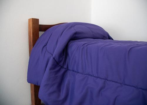 Ένα ή περισσότερα κρεβάτια σε δωμάτιο στο GOa Hospedajes
