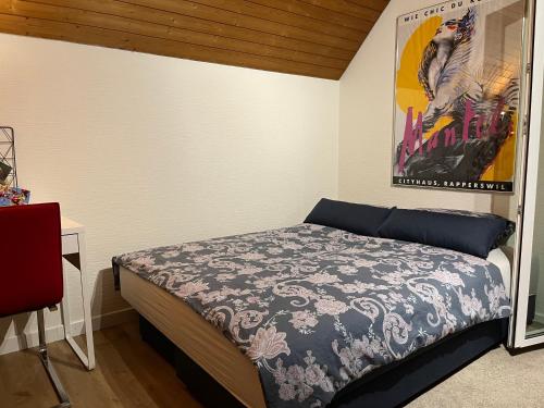 a bedroom with a bed and a poster on the wall at Studio Wettingen möbliert, 25min bis Zürich in Wettingen