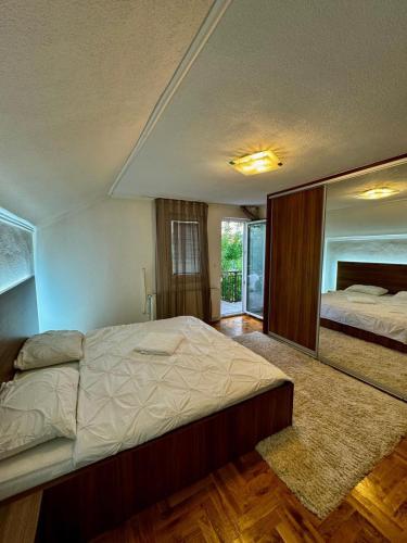 a bedroom with a large bed and a mirror at Stay and Chill house in Doglodi